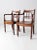 This is a pair of antique wooden chairs. The Sheraton-style arm chairs feature turned wooden spindle top slat backs and...