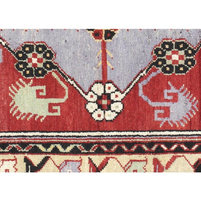 This vintage Turkish Oushak rug, measuring 3' by 5', is expertly handwoven with wool on a wool foundation in the Oushak...