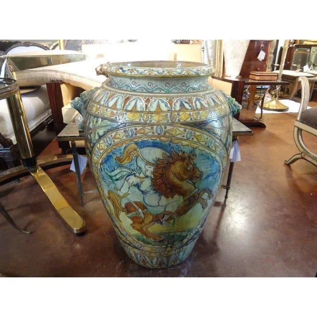 Italian glazed terra cotta Urbino Majolica style urn or vessel in muted colors with well detailed horse motif and lion...