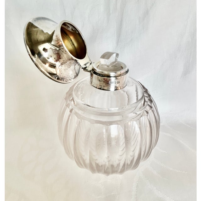 A beautiful pair of antique English crystal vanity bottles by Henry Clifford Davis, hallmarked Birmingham, sterling, 1919....