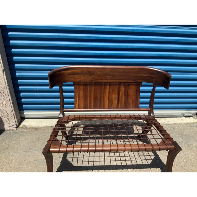 Modern walnut Klismos style settee/bench. The bench is made of solid walnut. The leather cording on seat is flawless. The...