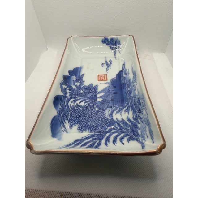 According to antique app Curio, this Chinese blue and white porcelain rectangular dish is from the Qing Dynasty in the...