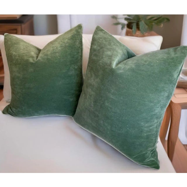 One Pair of muted green antique style velvet pillows measuring 20 x 20 inches with exposed brass zipper closures. Very...
