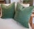 One Pair of muted green antique style velvet pillows measuring 20 x 20 inches with exposed brass zipper closures. Very...