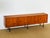 Magnificent minimalist vintage Scandinavian teak sideboard dating from the 1960s. Features four storage doors. Black metal...