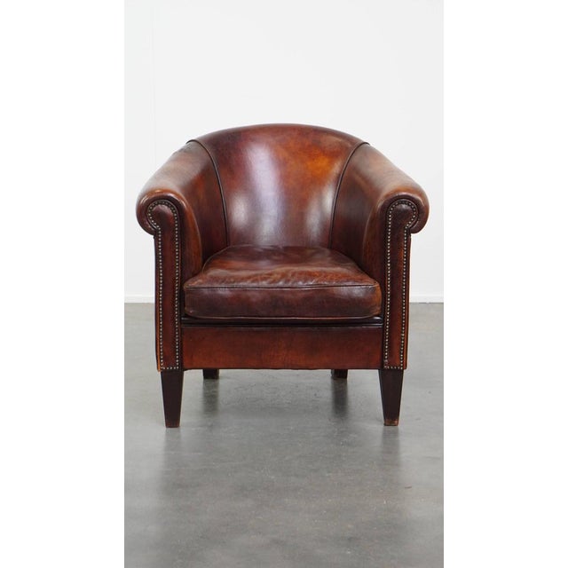 Offered is this sheep leather club chair in a beautiful warm cognac color with a beautiful patina. This sheep leather club...
