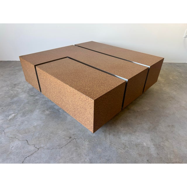 A bold and sculptural 1980s postmodern square coffee table, featuring a striking laminated tortoiseshell finish contrasted...