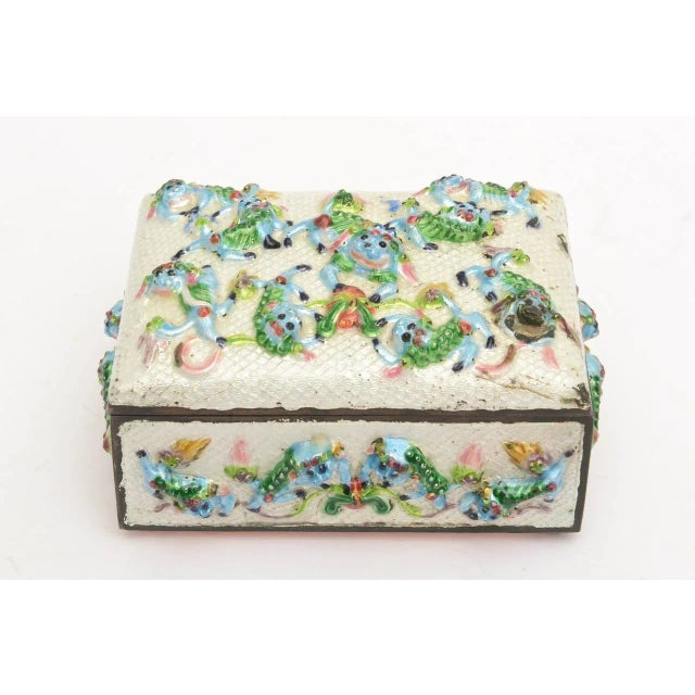 This remarkable VINTAGE CHINESE " good luck" hinged box has pushed out textural enamel jumping and leaping frogs and foo...