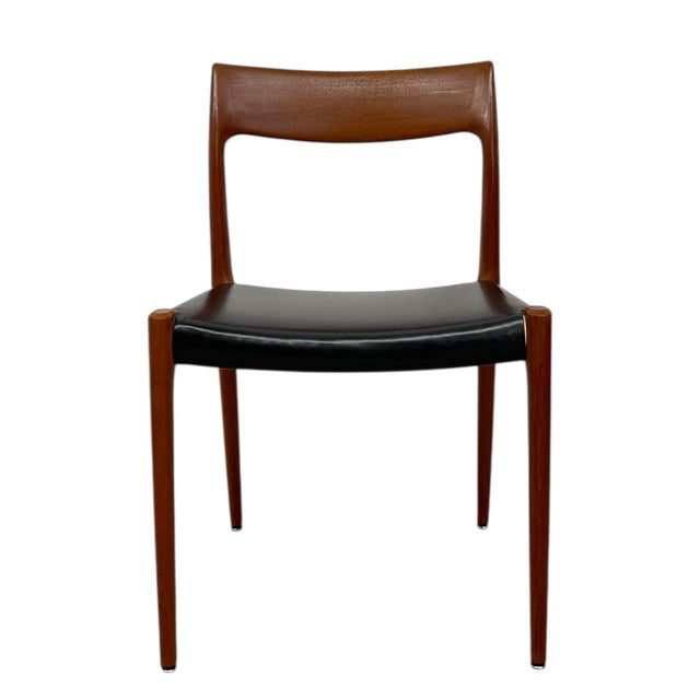 A Danish Mid Century Modern dining chair designed for J.L. Møllers Møbelfabrik. Made in Denmark, this chair carries the...