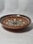 This Troyan Bulgarian redware pottery decorative plate is a fine example of traditional Balkan craftsmanship, renowned for...