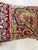 Decorative pillow upholstered in a 19th century Kerman rug fragment, featuring charming floral flowerhead motifs and an...