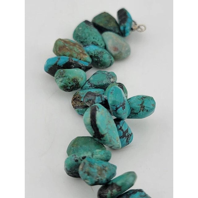 This vintage bracelet features gorgeous all-natural chunks of turquoise nuggets, showcasing a beautiful blue color in a...