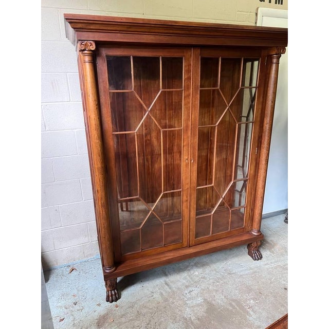 Antique American Empire Carved Mahogany BookcaseA Solid wood frame with carved lion paw feet Wooden Shelves are removable...