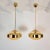 Pair of Mid-Century Modern pendant lights, Italy 1970s. The chandeliers are made of polished brass mounts and 2 hand-blown...