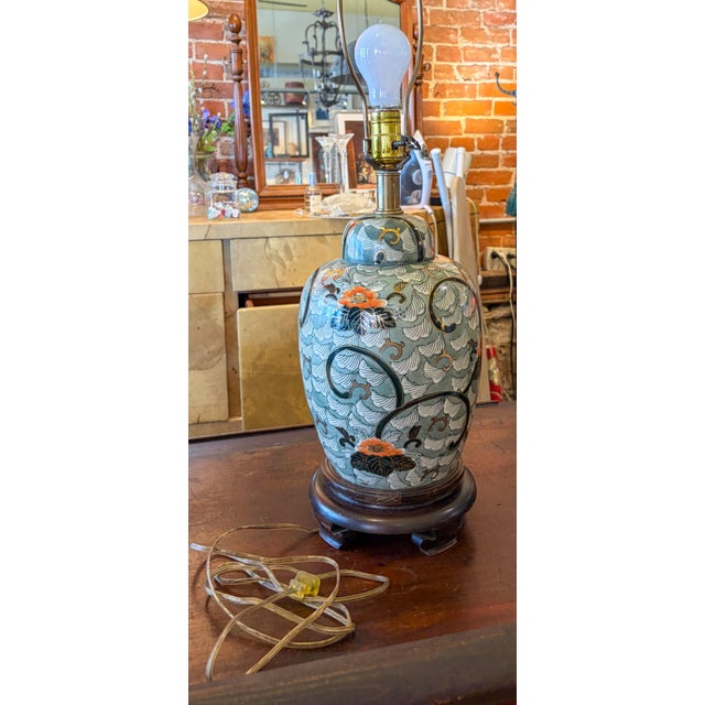 lovely little Frederick Cooper table lamp in the Chinoiserie style with hues of green, orange and gold. On a wood base....