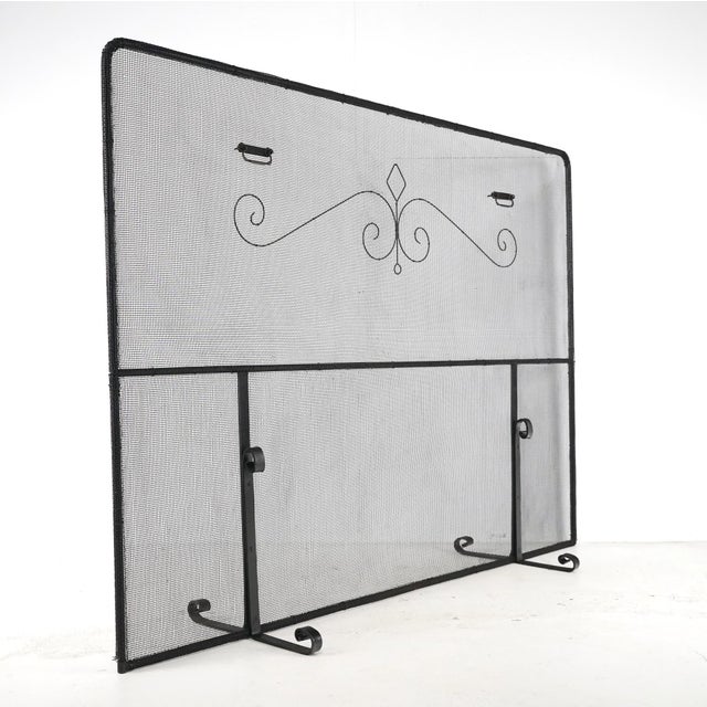 Antique fireplace screen made of black mesh steel in a rectangular shape with a wrought iron frame and supports. Good...