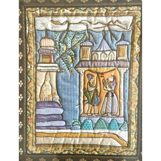 Pair of framed Persian Mughal pieces of art. Quilted textile of a scene, framed in a bamboo frame. Finished with a ribbon...