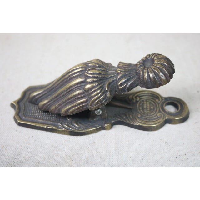 A late 19th Century brass paperclip in the form of a Victorian drapery tassel. Oversized paperclips such as this one were...