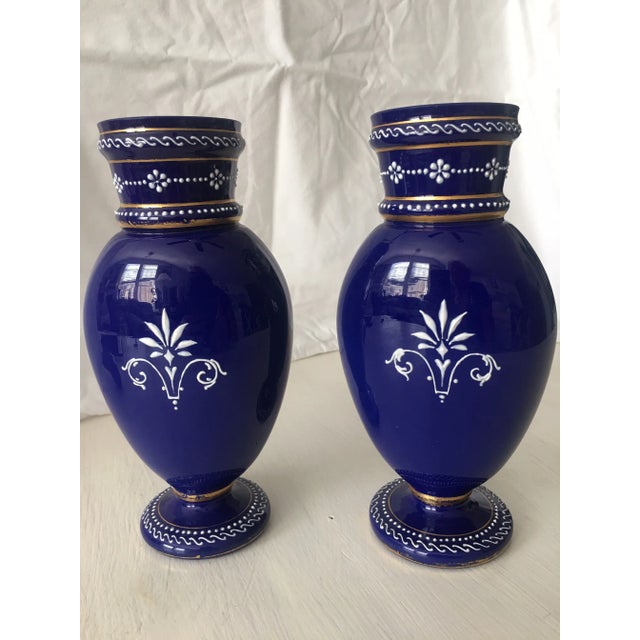 Pair of cobalt ground vases with white pate’ sur pate’. Figures from classical antiquity, beading, recumbent S patterning....