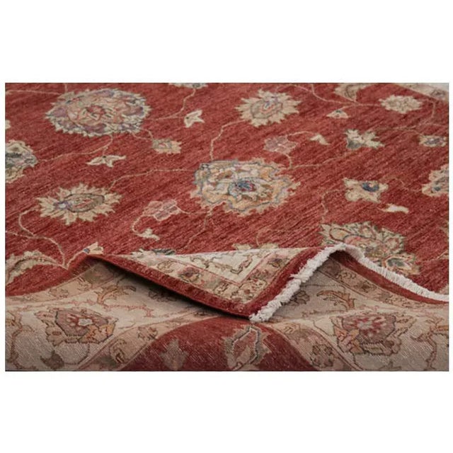 Handwoven Indian rug with Agra design on a red colored field and ivory border accented in shades of green, blue, and gold....