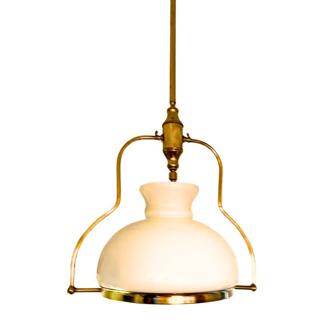 Elegant and timeless, this 1950s pendant light combines the warm glow of opaline glass with the sophistication of a brass...
