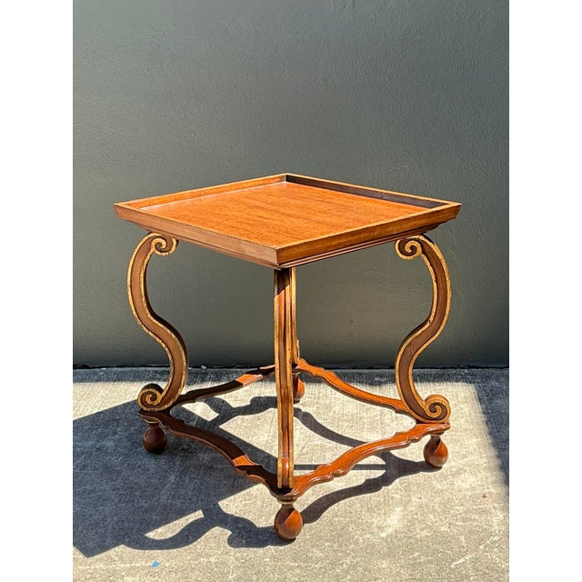 This sophisticated vintage side table is a masterclass in Hollywood Regency glamour, offering a striking sculptural...