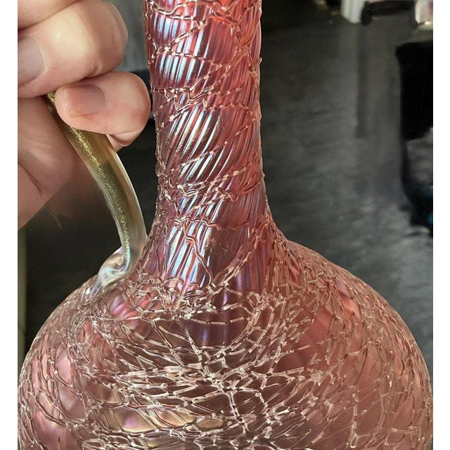 An exceptionally rare and beautiful pair of antique loetz claret jugs, attributed to the celebrated bohemian glassworks...