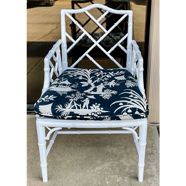 This is a 1970s white lacquer Chinese Chippendale style faux bamboo arm chair. The finish is a white lacquer. The seat is...