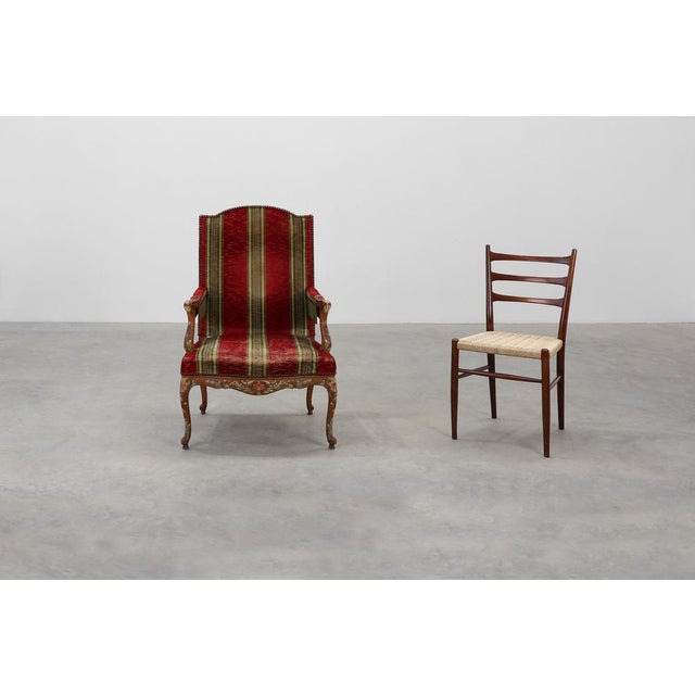 A richly detailed 19th‑century French armchair crafted in oak and inspired by the grandeur of the Louis XIV style. This...