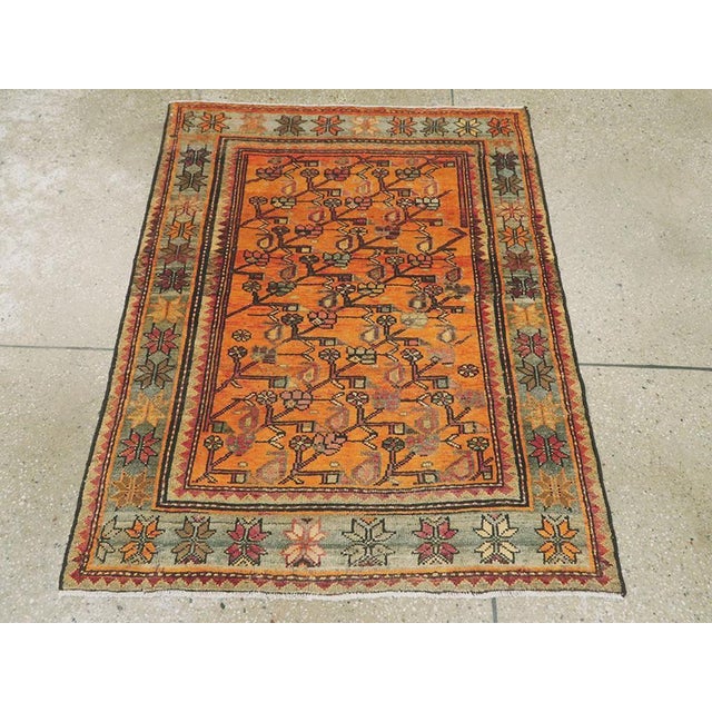 A vintage Persian Malayer throw rug. The abrashed rust-pumpkin field displays straight flower and boteh diagonal stems...