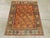 A vintage Persian Malayer throw rug. The abrashed rust-pumpkin field displays straight flower and boteh diagonal stems...