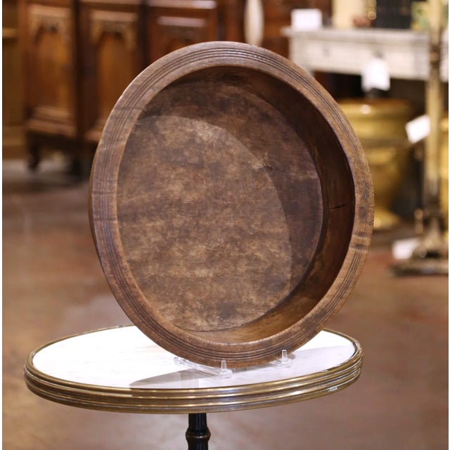 Crafted in France circa 1880, this large round dough bowl is hand-turned from solid elm, a hardwood prized for its...