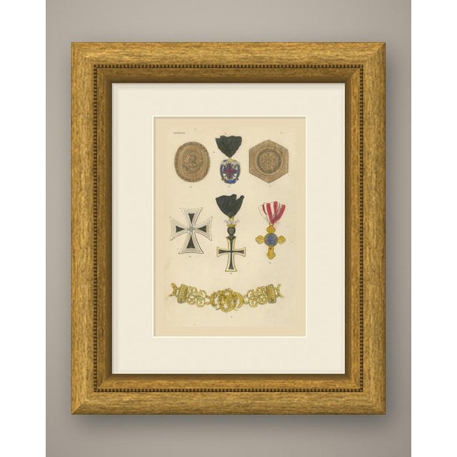 An original antique wood engraving, colored by hand with watercolor, showing seven austrian insignia. At the top are a...