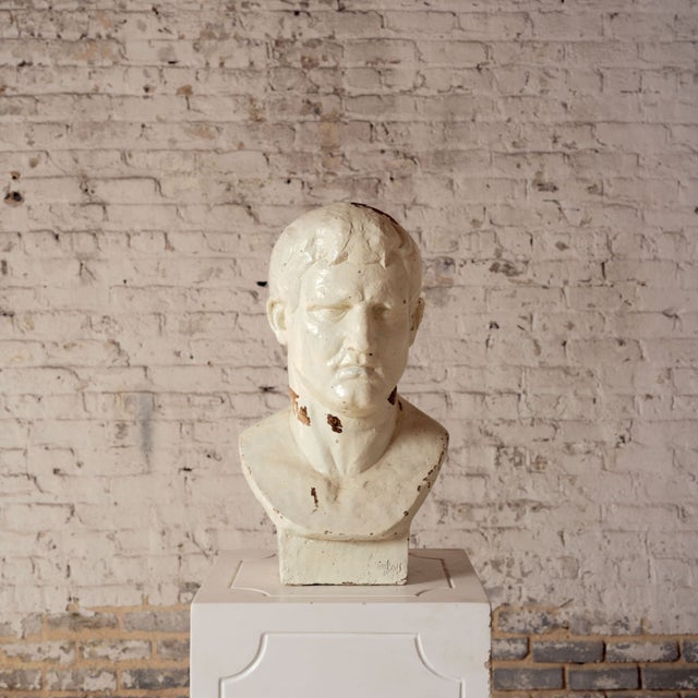 Elevate your space with this striking 20th century French male plaster bust, a timeless sculptural piece that embodies...