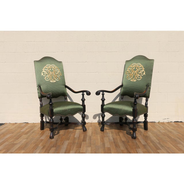 Wonderful pair of early 20th century antique high-back throne armchairs featuring beautifully carved dark solid wood...