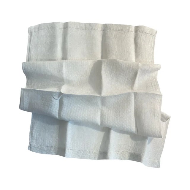 "A quietly exquisite antique French linen towel, woven in fine linen damask with a subtle diamond motif that reveals...