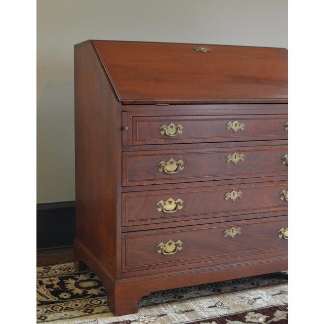 A slant front secretary desk in the Chippendale style, unbranded, likely made by Hickory MFG or similar. Solid genuine...