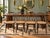A set of four vintage bentwood chairs, likely Thonet or Thonet-style, featuring classic curved wood frames and woven cane...