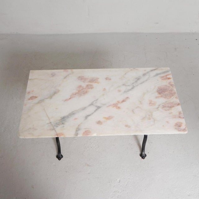 This table can be easily moved in 2 stages. The marble top rests loosely on the cast iron frame. The cast iron frame is...