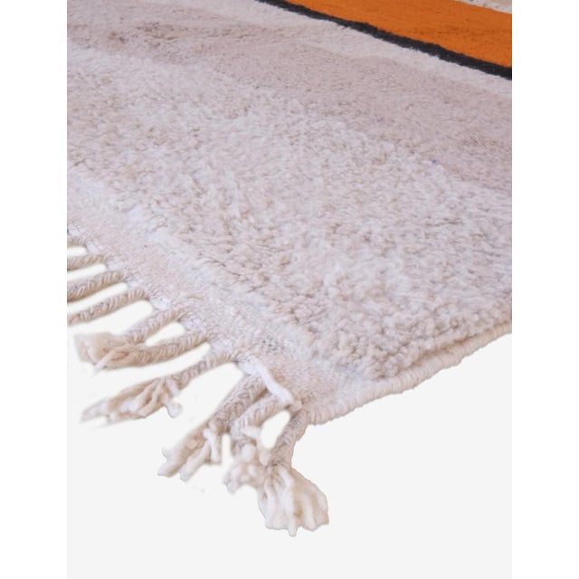 This vibrant contemporary Moroccan wool rug, measuring 8.8 by 7.2 feet (269 by 220 cm), showcases exquisite handwoven...