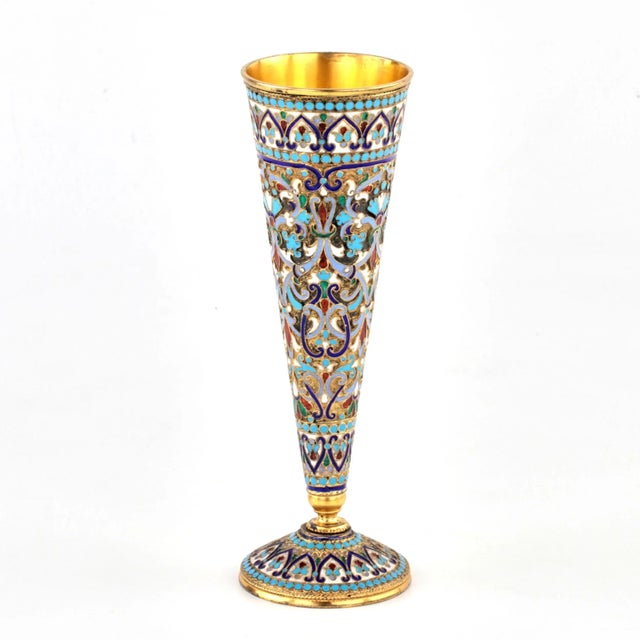 Luxurious tableware. Gilded silver champagne glass in cloisonné enamel. Simple but recognizable conical shape, completely...