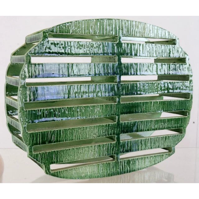 This remarkable freestanding ceramic artwork, in lush vegetable tones, shows an elegant elliptical shape with a continuous...