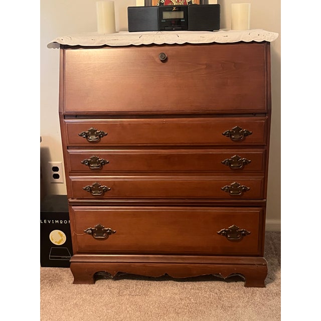 Add sophisticated storage density and timeless warmth to your space with this handsome vintage 1960s–1970s Traditional...