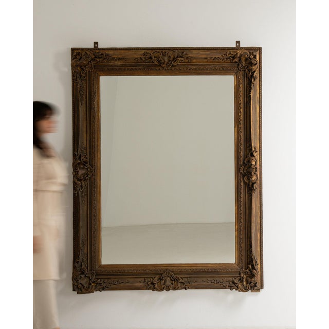 This mirror makes its impression through dark bronze ornate carved frame, rectangular. The piece dates to 19th Century,...