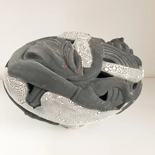 This subtle and stylish raku vase from Jinsong Kim, a female ceramicist based in Florida. This piece features a woman...