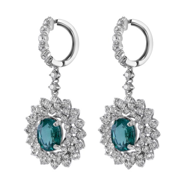 Beautiful natural oval emerald drop with natural mixed shape diamonds earrings. 4.52 carats total gemstone weight. 2 oval...