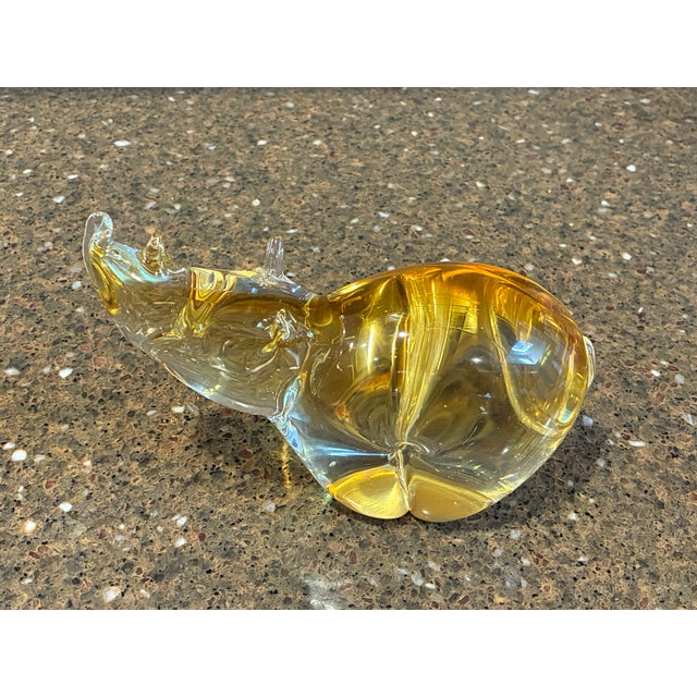 The sculpture is crafted using solid, heavy leaded glass with an internal sommerso amber and gold gradient color that...