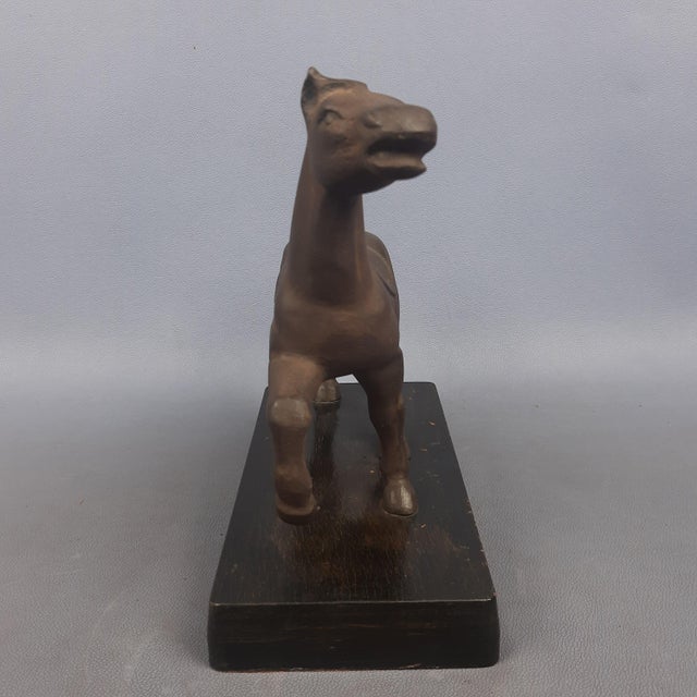 Spectacular contemporary art sculpture, statue depicting a horse, handcrafted in burnished cast iron on a wooden base....