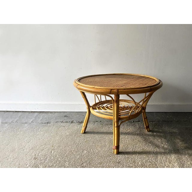 An Italian vintage bamboo and rattan occasional table, dating from the 1960s-70s. The circular top features hand-woven...