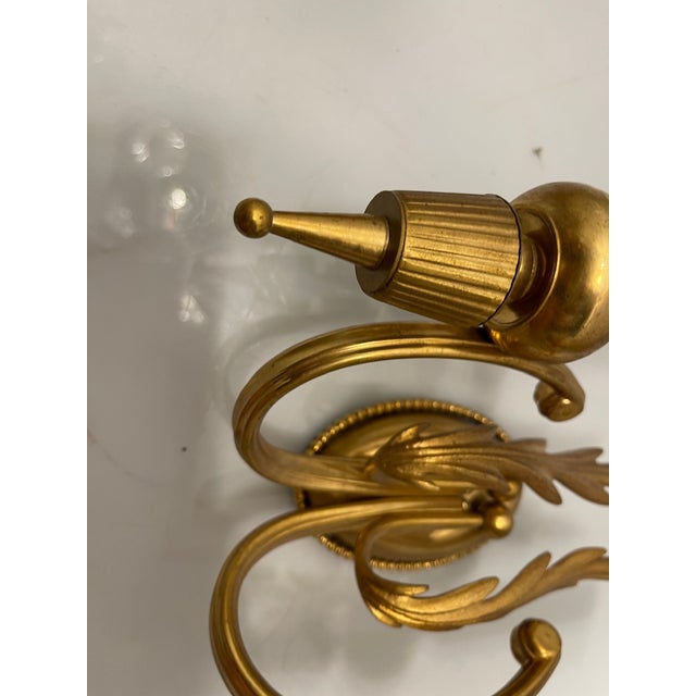 Pair of italian brass sconces, 1970s this striking set of two vintage italian wall sconces from the 1970s showcases...
